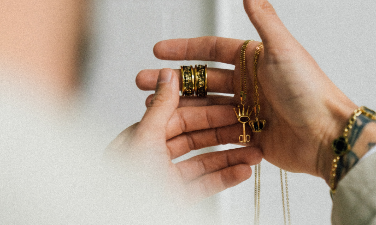 close up of man holding symbolic gold jewelry 