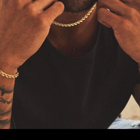 Model wearing a gold rope chain and rope bracelet